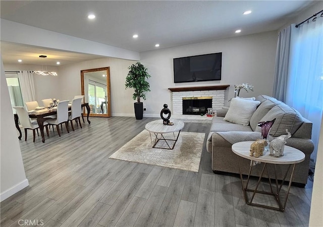 living room with wood-type flooring and a fireplace