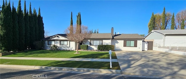 ranch-style house with a garage and a front yard