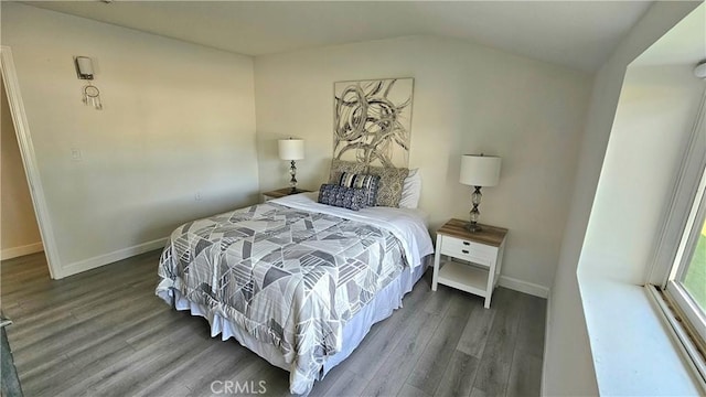 bedroom featuring lofted ceiling and wood-type flooring