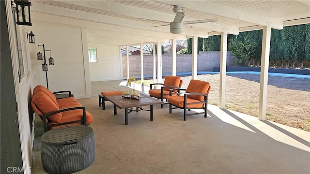 sunroom featuring beam ceiling and ceiling fan