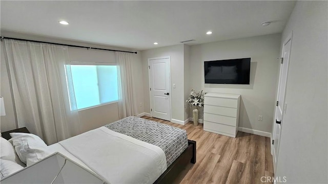 bedroom with light hardwood / wood-style floors