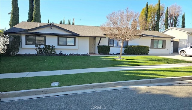 ranch-style home with a front lawn