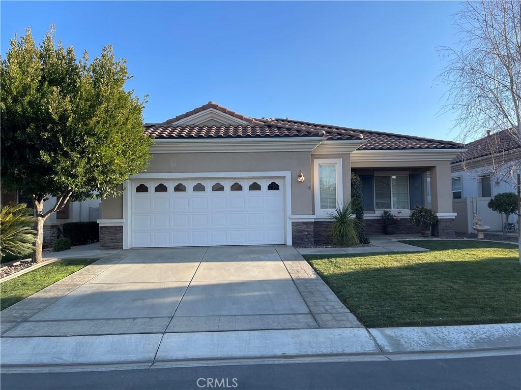 view of front of house with a garage and a front yard