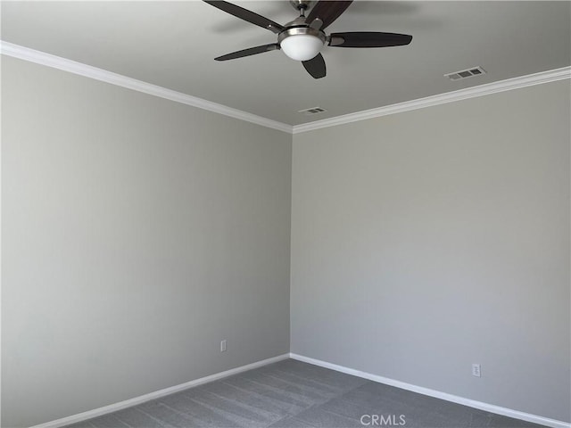 empty room featuring baseboards, dark carpet, visible vents, and crown molding