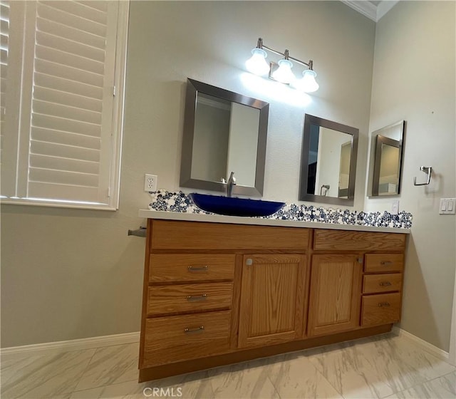 bathroom featuring marble finish floor, baseboards, and vanity