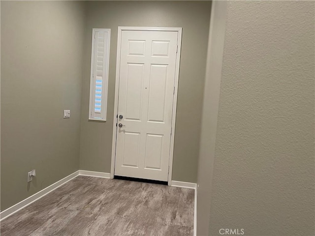 entryway featuring baseboards and light wood finished floors