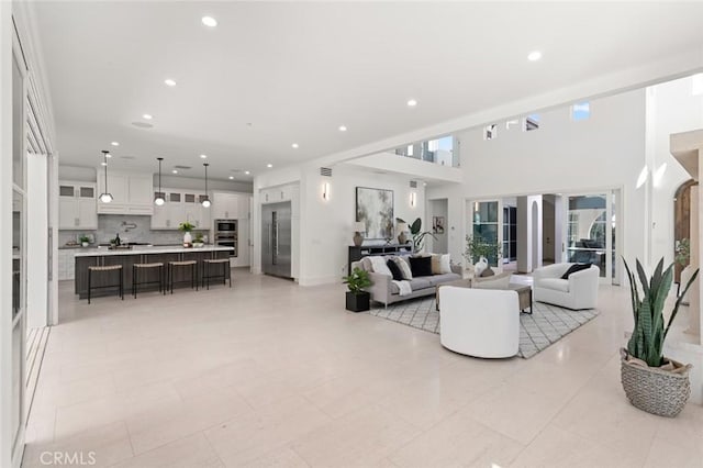 living room featuring a towering ceiling