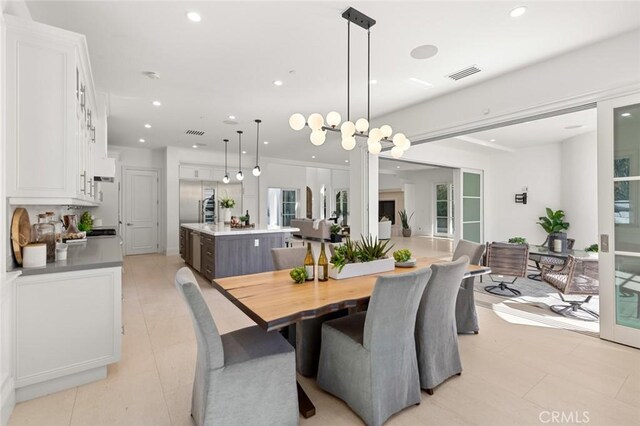 dining room with light tile patterned floors and an inviting chandelier