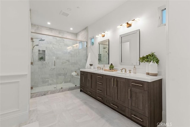 bathroom featuring vanity and a shower with door