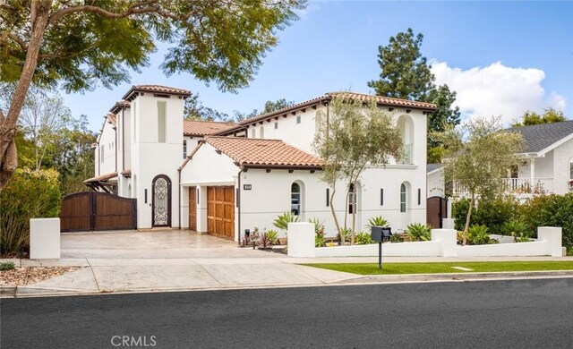 mediterranean / spanish-style house with a garage