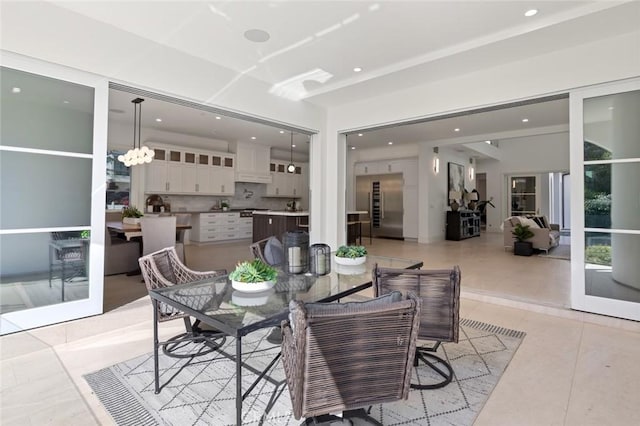 dining space with a notable chandelier and light tile patterned flooring