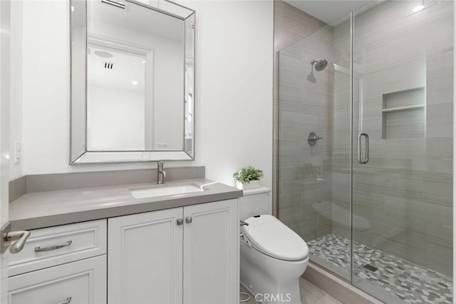 bathroom with vanity, an enclosed shower, and toilet