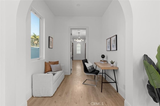 office featuring light hardwood / wood-style flooring and a notable chandelier