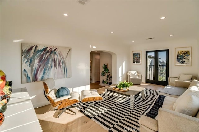 living room featuring french doors and light wood-type flooring