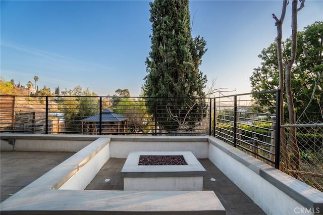 patio terrace at dusk with an outdoor fire pit