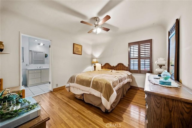 bedroom featuring ceiling fan, connected bathroom, and light wood-type flooring