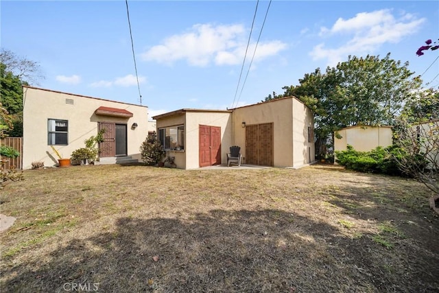 rear view of property with a yard