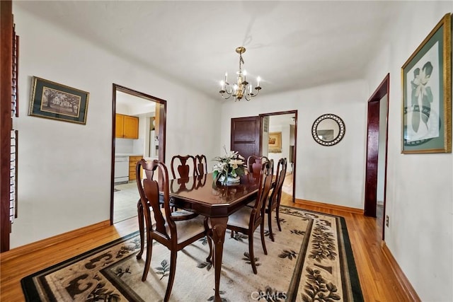 dining room featuring an inviting chandelier and light wood-type flooring