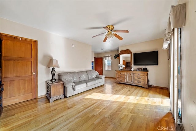 living room with ceiling fan and light hardwood / wood-style floors