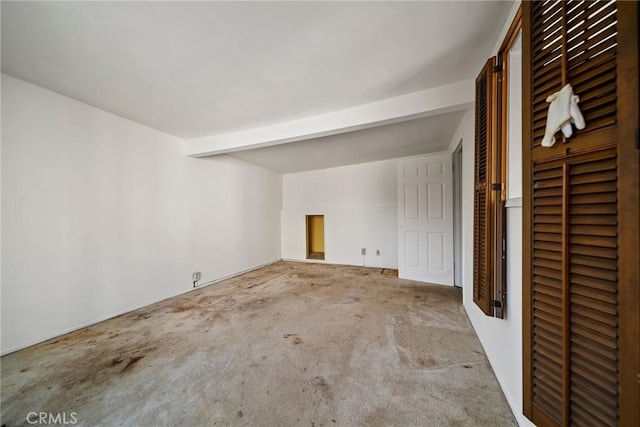 unfurnished room featuring light colored carpet