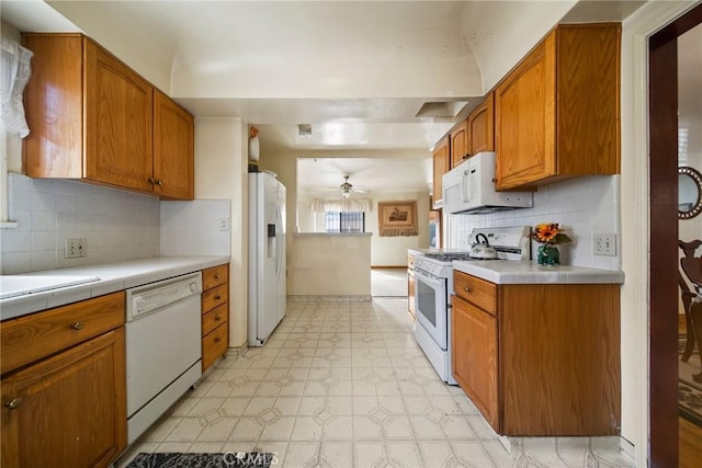 kitchen with ceiling fan, backsplash, and white appliances