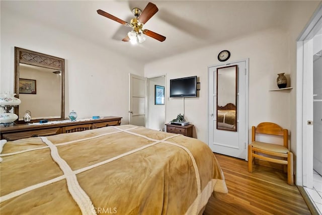 bedroom with hardwood / wood-style floors and ceiling fan