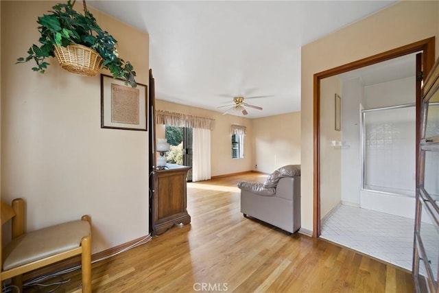 living room featuring ceiling fan and light wood-type flooring