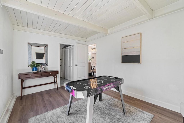 rec room featuring beamed ceiling, wooden ceiling, and hardwood / wood-style flooring