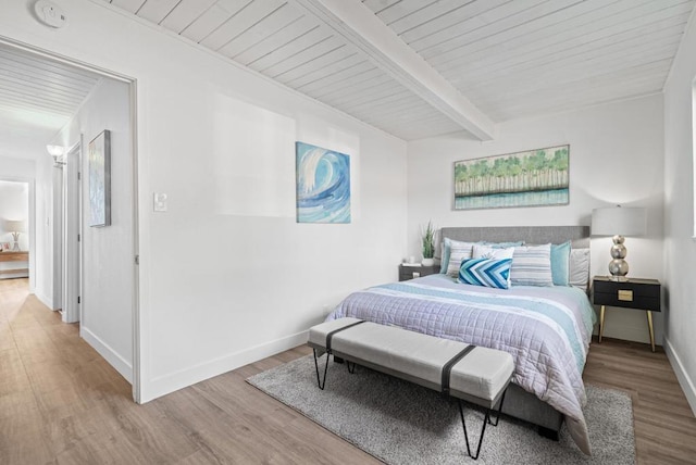 bedroom featuring wood ceiling, wood-type flooring, and beamed ceiling