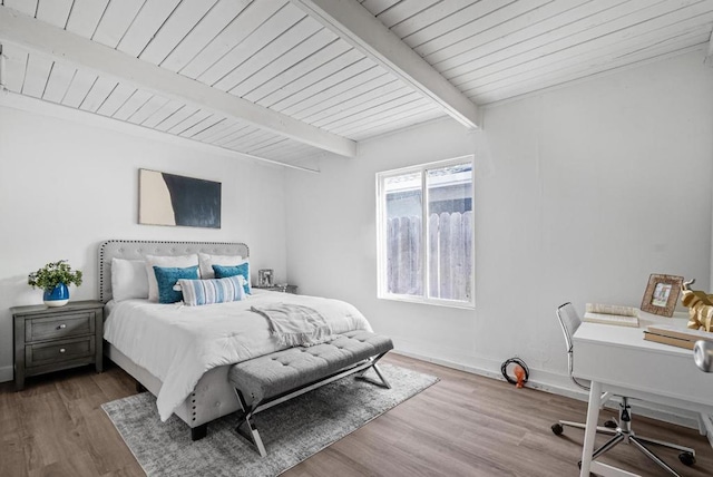 bedroom featuring wood ceiling, wood-type flooring, and beamed ceiling