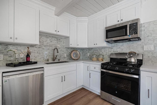 kitchen featuring white cabinetry, appliances with stainless steel finishes, sink, and backsplash