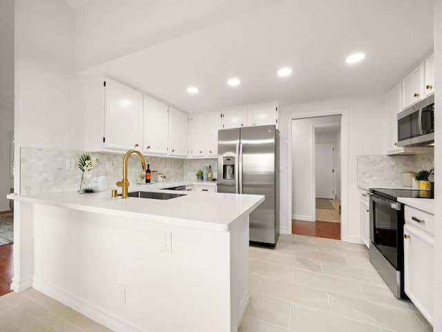 kitchen featuring stainless steel appliances, sink, and white cabinets