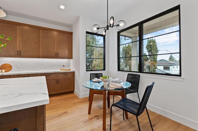 dining area with a chandelier and light wood-type flooring