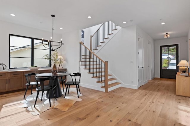 dining space featuring an inviting chandelier and light wood-type flooring