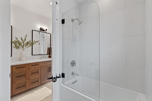 bathroom with vanity and tiled shower / bath combo