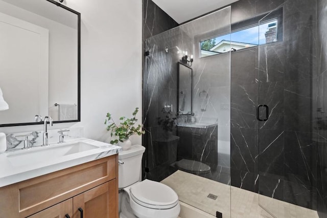 bathroom with an enclosed shower, vanity, and toilet