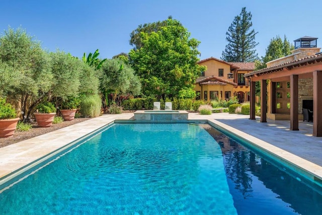 view of pool featuring a patio and an in ground hot tub