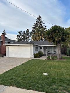 single story home featuring a garage and a front yard