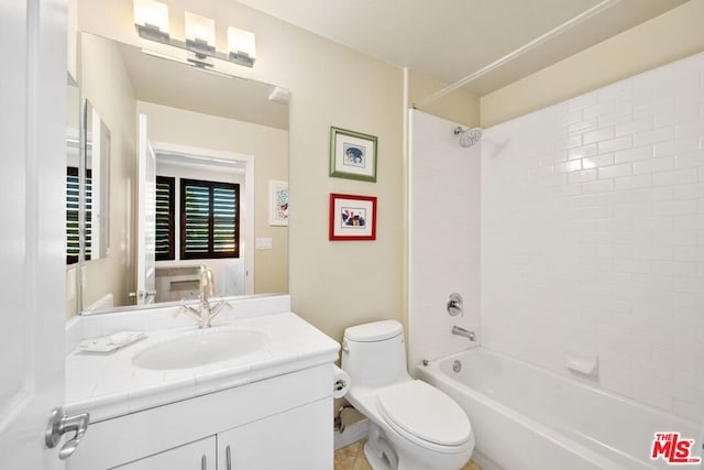 full bathroom featuring vanity, tiled shower / bath combo, and toilet