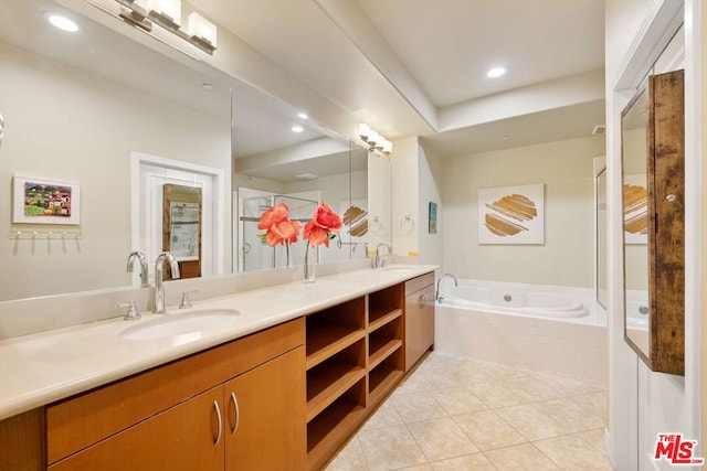 bathroom featuring vanity, tiled bath, and tile patterned floors