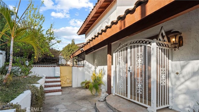 view of gate featuring a patio