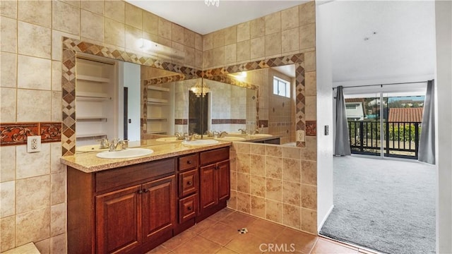 full bath with double vanity, tile patterned flooring, tile walls, and a sink