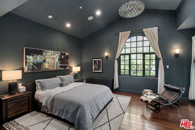 bedroom featuring wood-type flooring and high vaulted ceiling