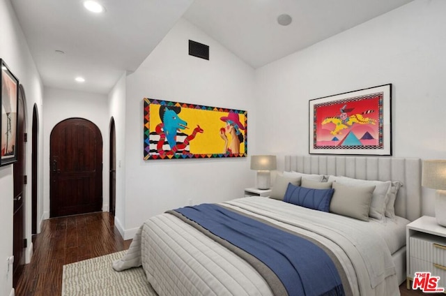 bedroom featuring dark hardwood / wood-style floors and vaulted ceiling