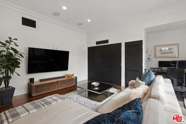 living room with dark wood-type flooring and crown molding