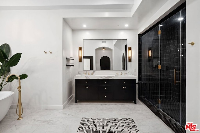 bathroom with vanity and independent shower and bath