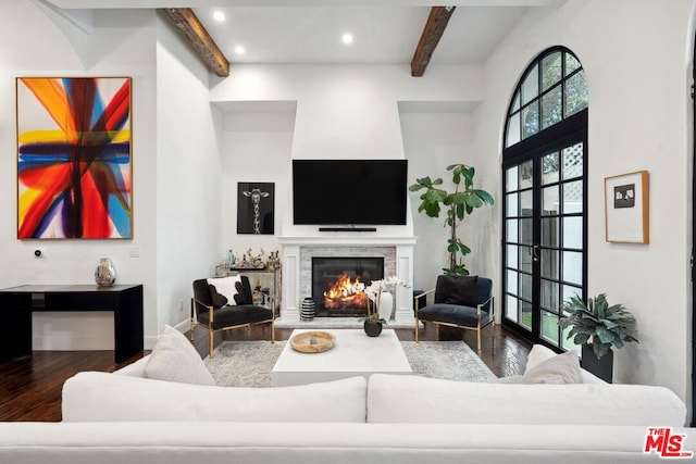 living room with hardwood / wood-style floors and beam ceiling