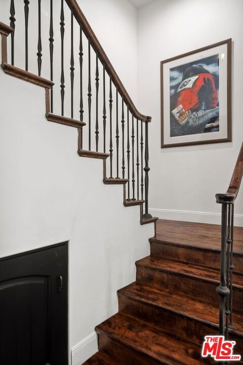 stairway featuring wood-type flooring