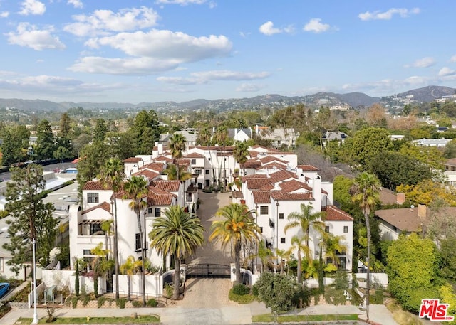 birds eye view of property with a mountain view