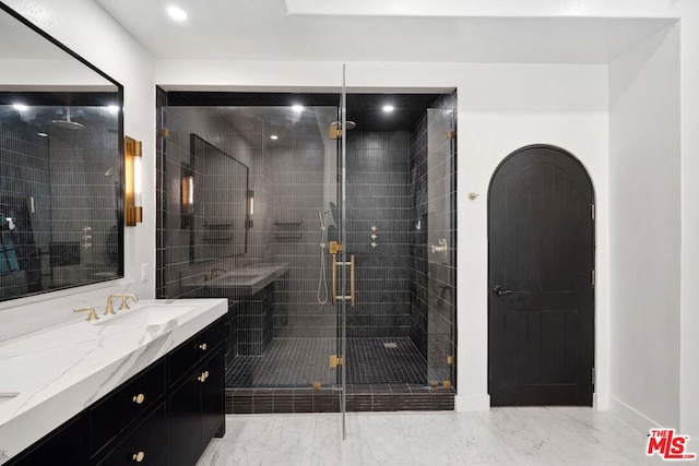 bathroom featuring vanity and a shower with shower door